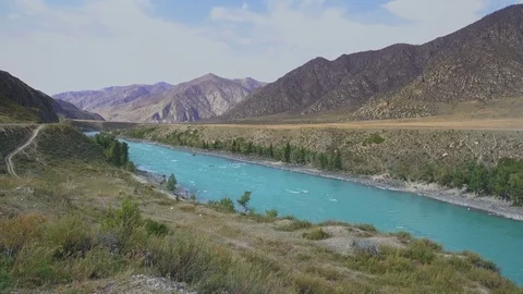 Wide Mointain River With Blue Water Slowly Flowing With The Mountain Range Stock Footage 70959856