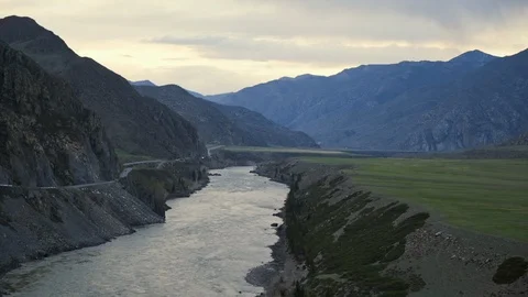 Wide mountain river flows between rocky shores. Highland with hills and plain Stock Footage 103108473