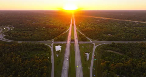 Wide multilane expressway crossroad with overpass ramps and flowing traffic in Stock Footage 312972152
