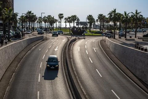 Wide multiple line auto road surrounded by green areas. Wide view of a main a Stock Photos