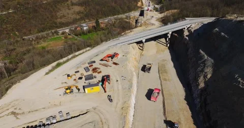 Wide New Road Plan Overlooking Heavy Traffic Small Rural Village Aerial Orbit Stock-Footage 300476937