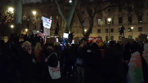 WIDE OF NIGHT CROWDS CHEERING DURING PROTEST FOLLOWING SARAH EVERARD VIGIL Stock Footage 150399186