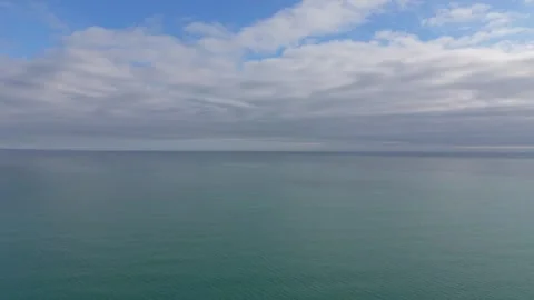 Wide ocean panorama with soft clouds and serene water surface Stock Footage 328572149