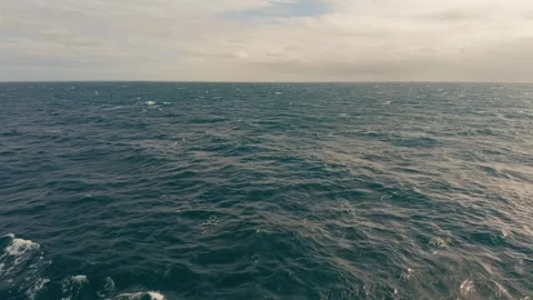 Wide ocean stretches under cloudy skies Stock Footage 342401878