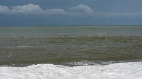 Wide Ocean Waves Breaking Under Cloudy Horizon Video stock 347996423
