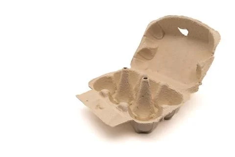 Wide open empty egg box for six eggs, isolated on white with copy space Stock Photos