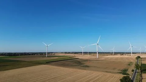 Wide open fields stretch beneath a clear blue sky Stock Photos