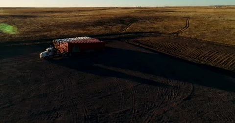 A wide orbit of a fracking pad during sunset as a large piece of equipment Stock Footage 167622958