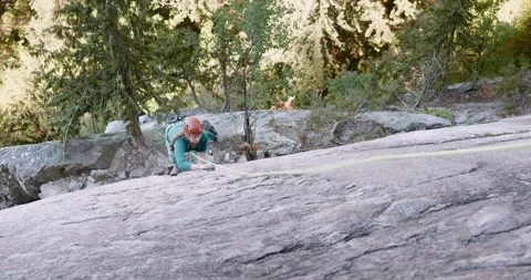 Wide overhead view of female rock climber on Stawamus Chief Grand Wall 4K Stock Footage