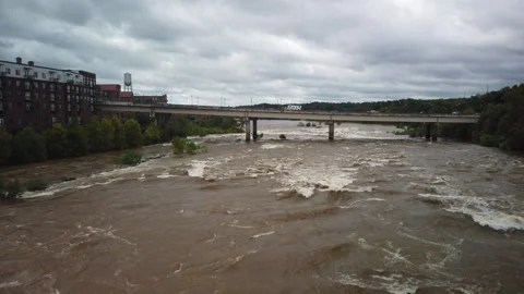 Wide Overhead view looking down at a swift fast moving, churning muddy clay brow Stock Footage 286852020