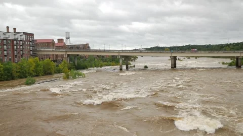 Wide Overhead view looking down at a swift fast moving, churning muddy clay brow Stock Footage 286853786