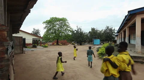 WIDE: PAKRO STUDENTS RUN TOWARDS SCHOOL Stock Footage 59735456