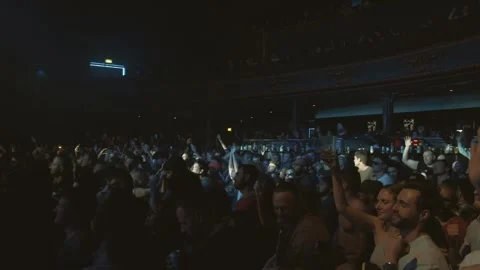 Wide pan across a crowd with thier hand in the air at a rave Stock-Footage 248171808