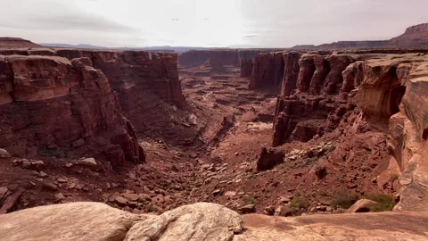 Wide Pan Across Deep Red Rock Canyon with Sandstone Cliffs Stock Footage 289686103