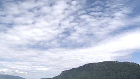 Wide pan down from sky to boats and sail boats in harbor Stock Footage 75487259