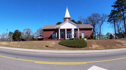 Wide pan Grove First Baptist Church on Robinson Ave and traffic blue sky day  Stock Footage 171303864