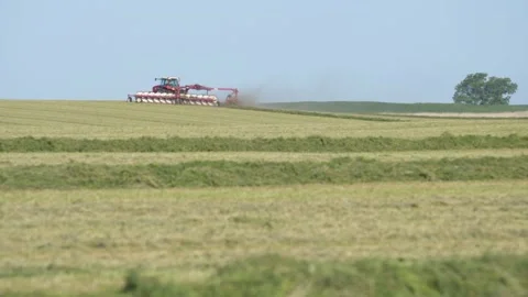 Wide Pan Left of Tractor and Rake Stock Footage 221861846
