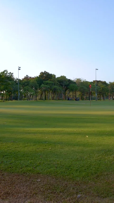 Wide Pan of Tropical Golf Course Green and Fairway at Sunset Stock Footage 337925792
