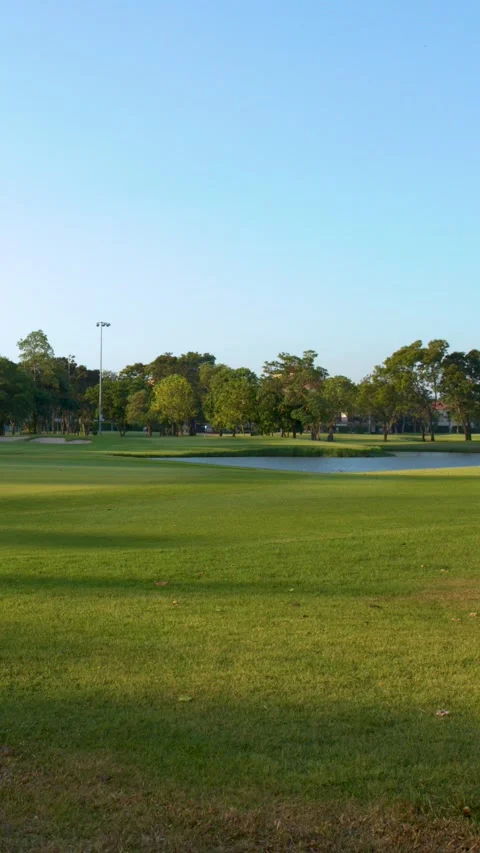 Wide Pan of Tropical Golf Course Fairway and Putting Green Stock Footage 337926056
