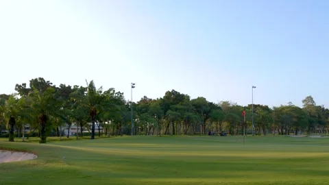 Wide Pan of Tropical Golf Course Green with Sand Bunker Stock Footage 338041796