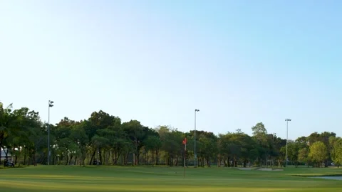 Wide Pan of Tropical Golf Course Green and Fairway at Sunset Stock Footage 338326825
