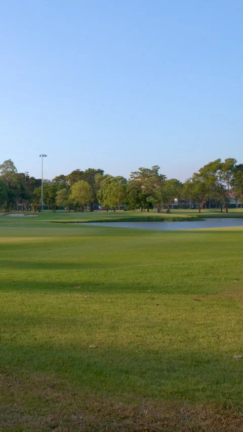 Wide Pan of Tropical Golf Course Fairway and Putting Green Stock Footage 339411269