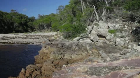 Wide pan with two young men of Bittangabee Bay Beach NSW Australia 動画素材 11281333