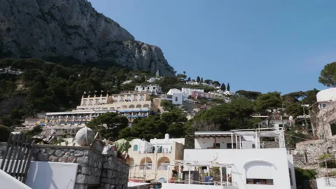 Wide panning shot of cliffs and buildings in Capri, Italy 4k Stock Footage 235593590