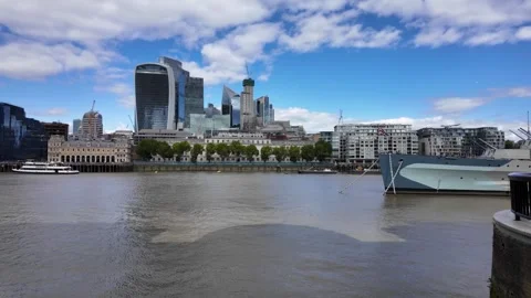 Wide panning view of River Thames with modern City of London skyline Stock Footage 346677500