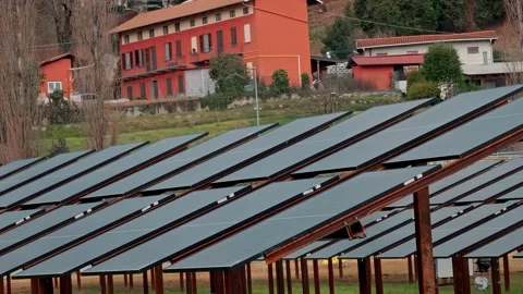 Wide panorama of brown solar cell array supplying renewable electricity near a Stock-Footage 330794728