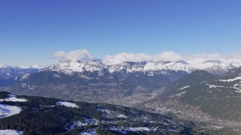 Wide panoramic aerial view of the snow-covered Alps mountains and forested hills Stock Footage 346666554