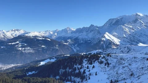 Wide panoramic aerial view of the snow-covered French Alps above Passy and Stock Footage 346668622