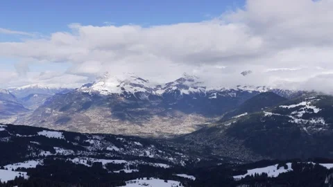 Wide panoramic aerial view of the snow-covered Alps in winter, showing the Stock Footage 346719311