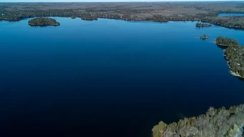 A wide panoramic drone photograph capturing a vast expanse of blue water on a Foto stock