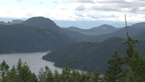 Wide panoramic of mountain range and ocean canal Stock Footage 75247047