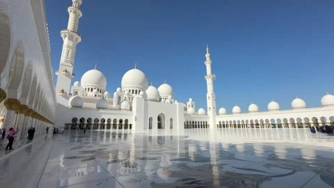 Wide panoramic shot of the Sheikh Zayed Grand Mosque inner courtyard with domes Stock Footage 327323030