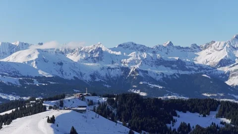 Wide panoramic shot of the snow-covered Alps mountains under a clear blue sky Stock Footage 346671725