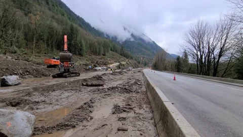 Wide Panoramic View of Backhoe Excavator Clearing Flood Mud Slide from Stock Footage 171575861