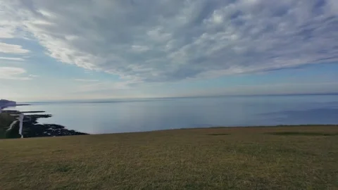 Wide Panoramic View From Clifftop Overlooking Ocean, Fields and White Cliffs Stock Footage 309767728