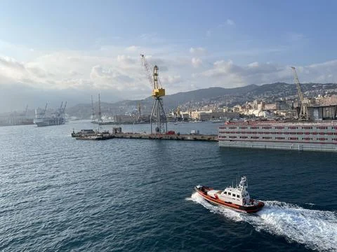 Wide panoramic view of the harbor of Genoa. Blue sky blue sea white clouds and Stock Photos