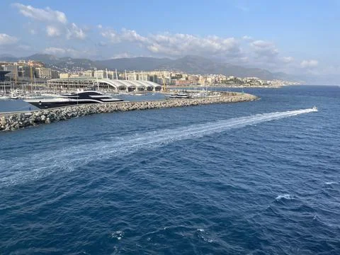 Wide panoramic view of the harbor of Genoa. Blue sky blue sea white clouds and Stock Photos