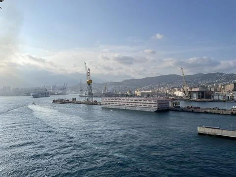 Wide panoramic view of the harbor of Genoa. Blue sky blue sea white clouds and Stock Photos