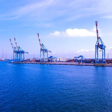 Wide panoramic view of the harbor of Genoa. Blue sky blue sea white clouds and Foto stock