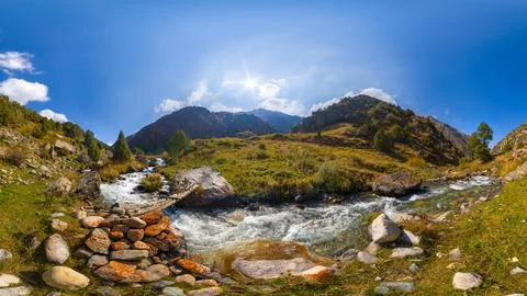 Wide panoramic view of a mountain valley with two converging streams, rocky Photos