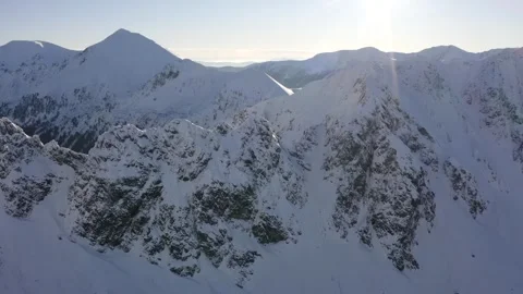 Wide Panoramic View of Snow-Capped Mountain Range in Winter Stock Footage 332260638