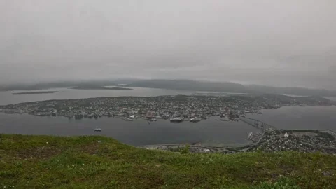 Wide panoramic view of Tromso city island and fjord from grassy mountain top Stock-Footage 341697310