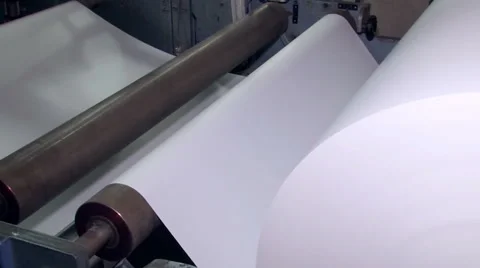 A wide paper roll is rotated on the machine for further cuts 4 Stock Footage 64846642