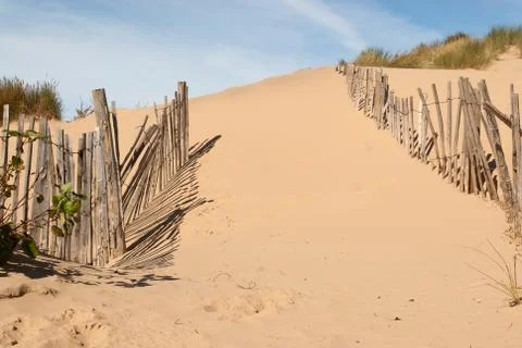 Wide path through old beach fence Stock Photos