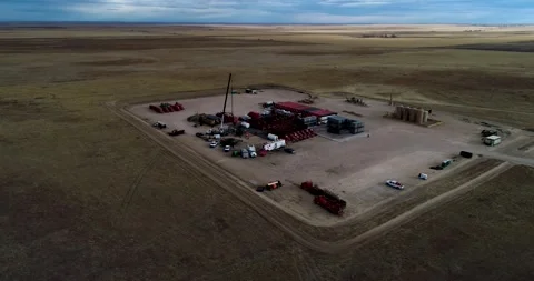 Wide perspective drone orbit of a hydraulic fracturing or fracking pad on Stock Footage 167396519