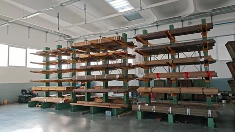 Wide perspective of green cantilever racks loaded with metal pipes. Factory Stock Footage 329293604